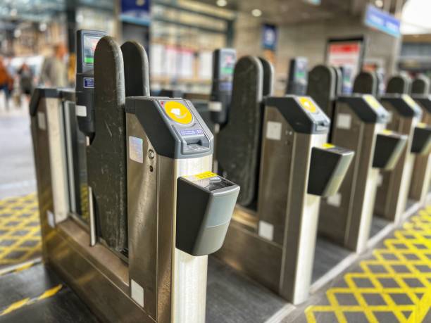 istock Modern electronic ticket barriers at railway station, with selective focus 1415736505