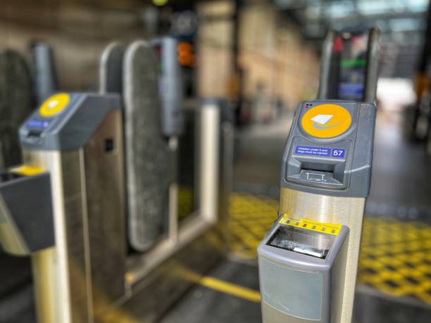 istock Modern electronic ticket barriers at railway station, with selective focus 1415736598