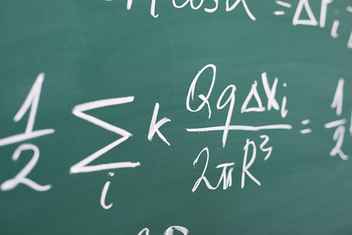 Mathematical formulas written on chalkboard.