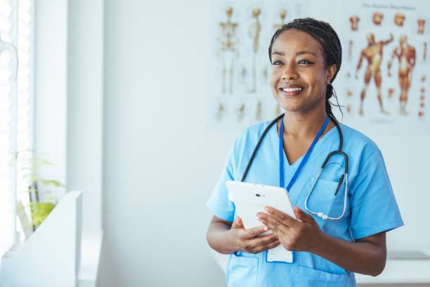 istock Smiling medical practitioner using a digital tablet in a hospital 1415737785