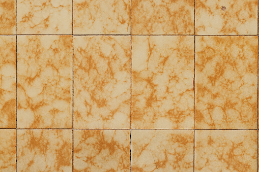 Close up, brown small square tile, repair concept. Ceramic tiles for the kitchen on the wall