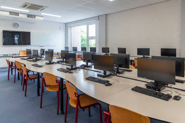 Computers in empty classroom on high school stock photo