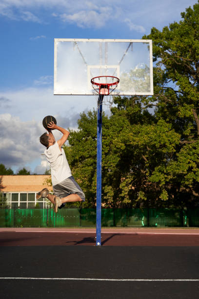 istock Basketball player in action flying high and scoring 1415741775