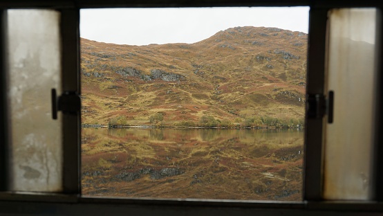 Autumn view in Loch Eilt view from moving train in Scottish Highlands, United Kingdom.