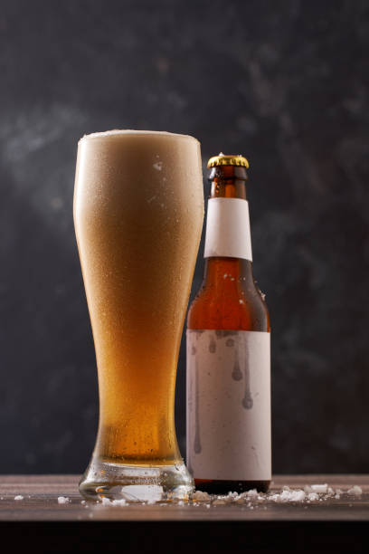 istock Bottle and glass of beer on black background. 1415744479