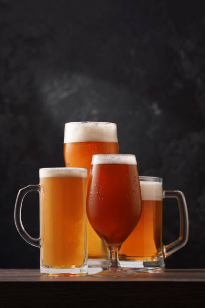 istock Four different glasses of beer on black background. 1415744551