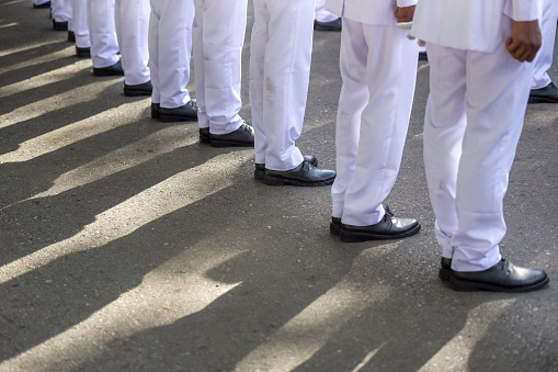 Line up during the parade of white costumes and black shoes