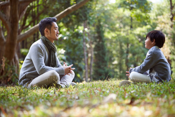 istock young asian father having a pleasant conversation with son outdoors 1415748924