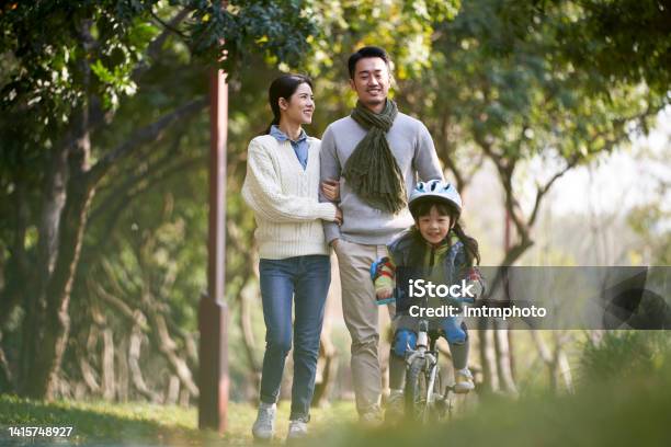 Young Asian Family With One Child Enjoying Outdoor Activity In Park Stock Photo - Download Image Now