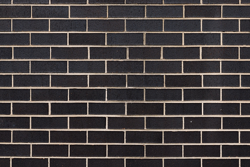 Section of a black brick wall.