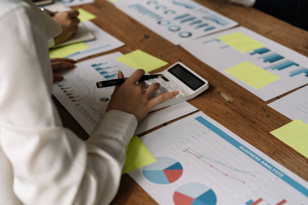 istock Business people discuss investment project working and planning strategy and using calculator during a business meeting 1415751115