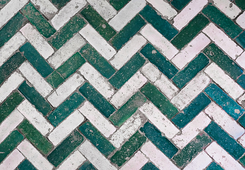 Full frame shot of green old ceramic floor tile in herringbone pattern