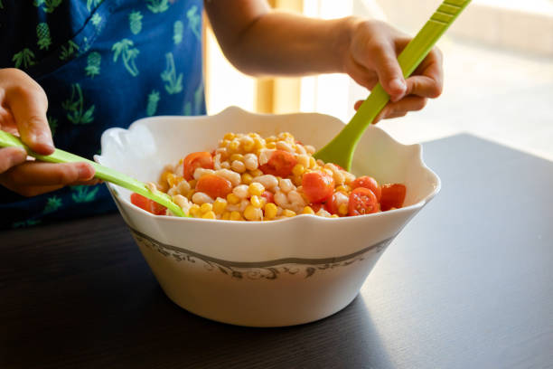 Fresh vegan vegetarian salad and vegetables. Southwestern salad with avocado, corn, tomato, and red bean. Food. Diet. Healthy eating. Rustic. Directly above view.
