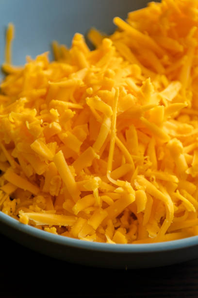 istock grated cheddar cheese on a plate on wood table 1415753133