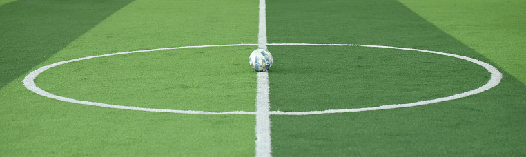 Close Up On Football Field With Artificial Grass And White Stripes