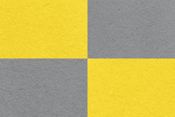 istock Texture of craft gray and yellow paper background with cells pattern, macro. Structure of vintage grey cardboard. 1415755953
