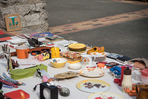 Trinkets spread out on the ground to be sold in a flea market