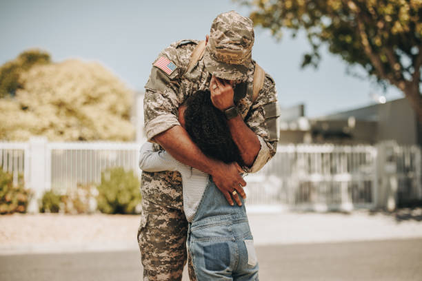 Tearful military parting Tearful military parting. Emotional soldier saying his goodbye to his daughter before going to war. Patriotic serviceman embracing his child before leaving to go serve his country in the army. female combat soldier stock pictures, royalty-free photos & images