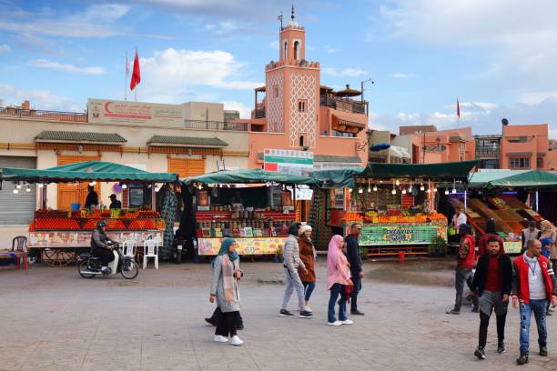 Jamaa el-Fnaa square, Marrakech People visit Jamaa el-Fnaa square market of Marrakech city, Morocco. The square is listed as UNESCO Masterpiece of Intangible Heritage of Humanity. djemma el fna square stock pictures, royalty-free photos & images