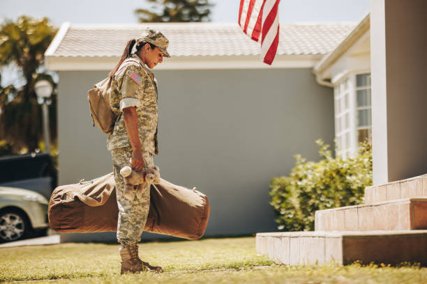 istock Patriotic military mom returning home from the army 1415757555