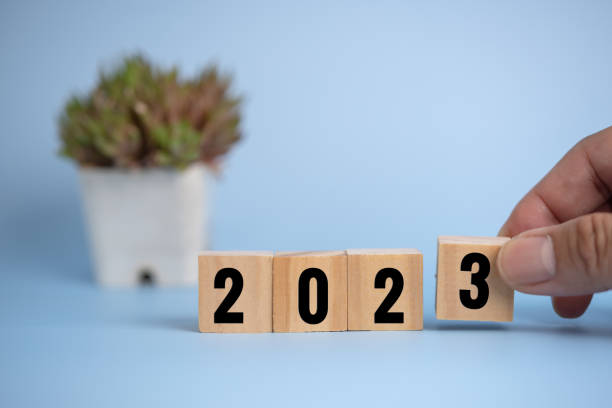 istock Hand man holding wood cube block 2023 on background. 1415758113