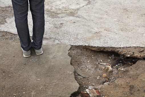 Broken pavement - dangerous sidewalk hole in Casablanca, Morocco. Hazardous holes and damaged concrete.