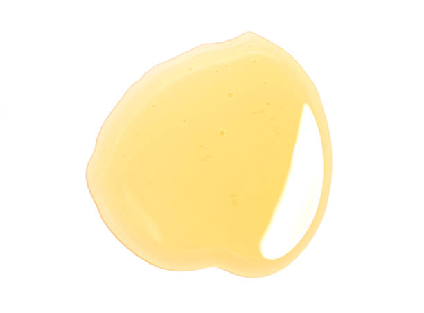istock Puddle of honey isolated over white background 1415759329