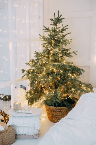 istock Decorated mirror and live Christmas tree with lights. New year's interior, festive atmosphere, decor, garlands, gifts. 1415760742