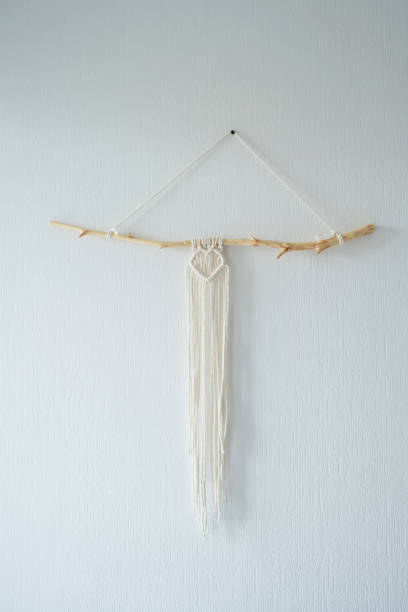 istock Handmade macrame panel hanging on the wall in the form of a heart 1415760898