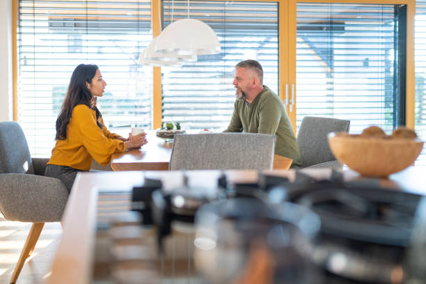 istock Mature man talking with young woman 1415761001