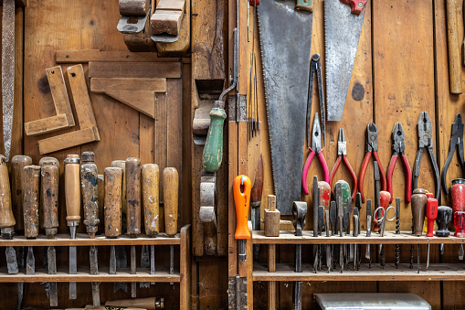 Different types of work tools arranged in workshop.