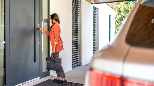 istock Woman's finger pressing on fingerprint scanner to enter her house 1415761195