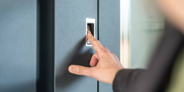 istock Man's finger pressing on fingerprint scanner to enter his house 1415762164
