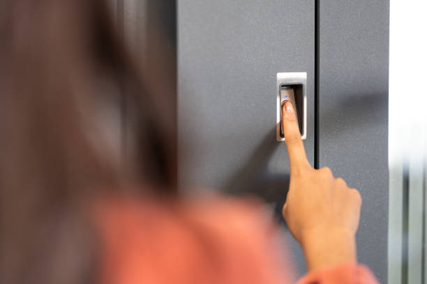 istock Woman's finger pressing on fingerprint scanner to enter her house 1415762166