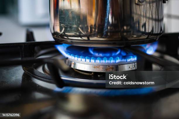 Cooking On Gas Hob In Kitchen With Blue Flames Burning Stock Photo - Download Image Now