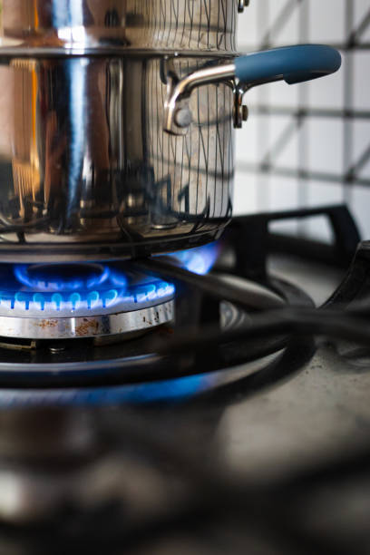 istock Cooking on gas hob in kitchen with blue flames burning 1415762426