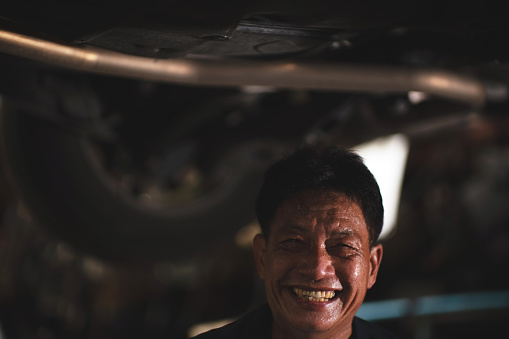 Portrait of auto mechanic senior man at auto repair shop. stock video