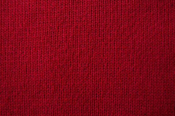 istock Knitted red pattern closeup, detailed yarn background. 1415764188