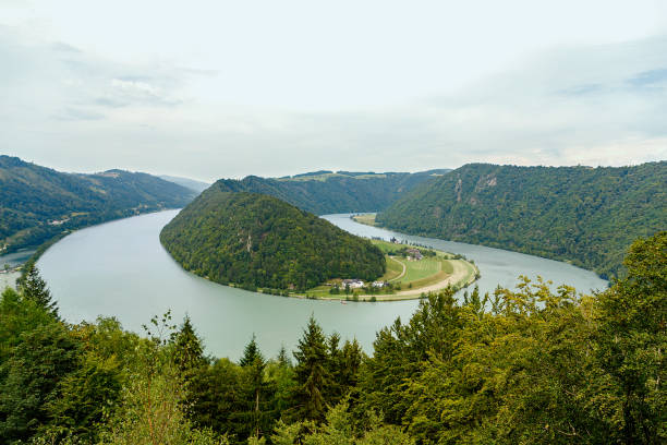 A scene of nature with a river through mountains and forests that can be used for backgrounds