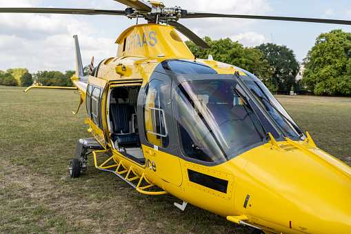 A TCAA helicopter is waiting for a patient in Regent's Park. The Children's Air Ambulance Service is a charity-funded air ambulance that transfers critically ill children from local hospitals to specialist pediatric centers across the UK.