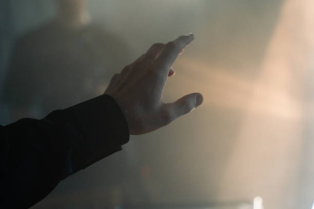 istock A human hand in a flashlight light in a dark smoked room 1415766654