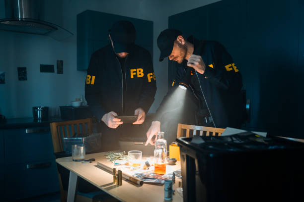 istock FBI agents working with physical evidences at the crime scene 1415766693