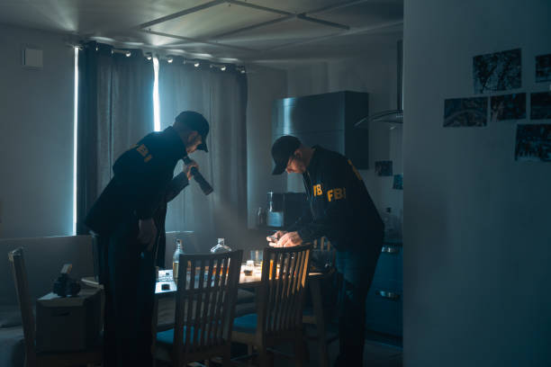 FBI agents working with physical evidences in a kitchen stock photo