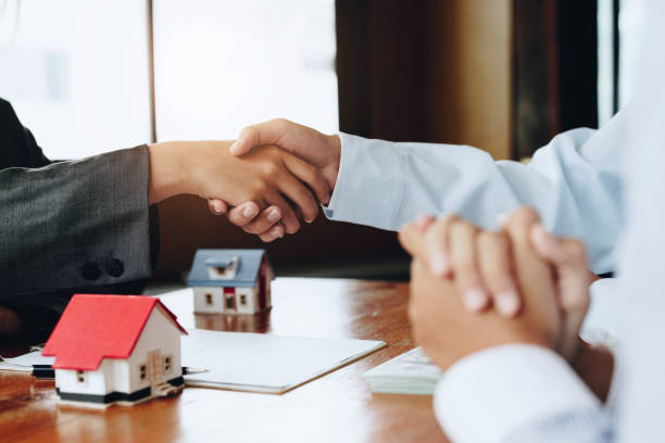istock Real estate agents shake hands with customers after signing documents 1415767309