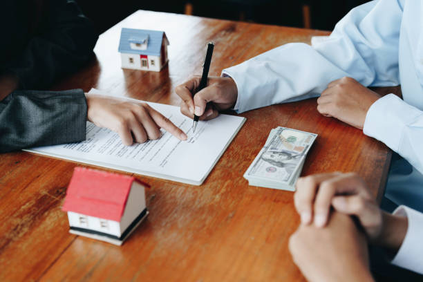 istock A couple is reading a home purchase contract before signing documents with a real estate agent 1415767331