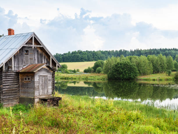 istock wooden cabin and calm river after summer rain 1415767435