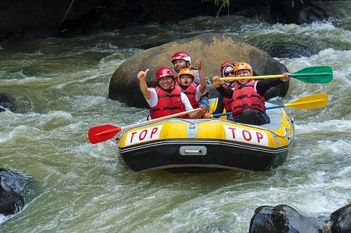 SUKABUMI, Indonesia - September 06, 2018 : A rafting team down the river on a beautiful sunny day.