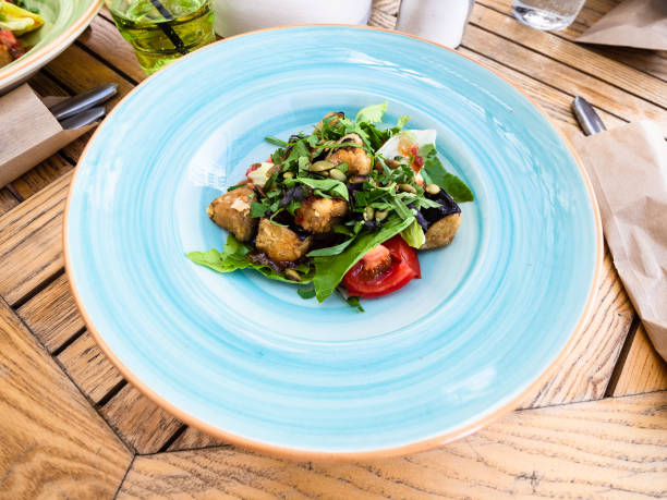 istock baked eggplant salad with tomatoes and greens 1415767778