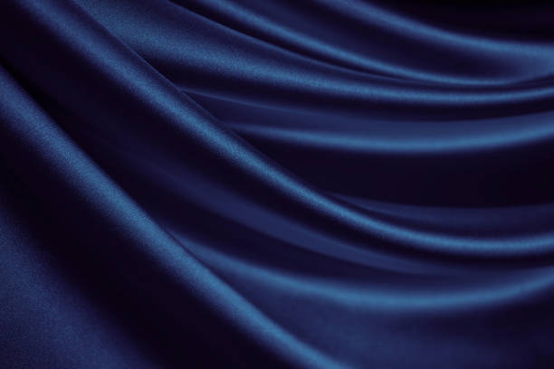 istock Black blue silk satin. Dark elegant background with space for design. Soft folds. Wavy. Shiny smooth fabric. 1415768846
