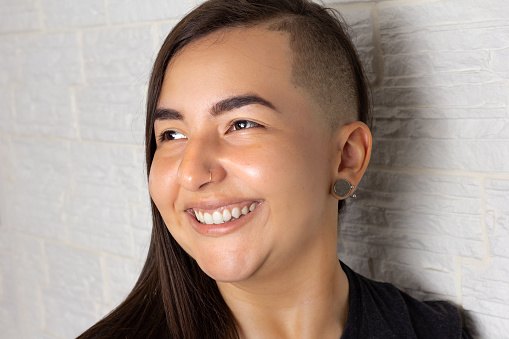 Portrait of a young overweight woman looking looking to the side, away.